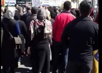Plundered women and men march in Tehran